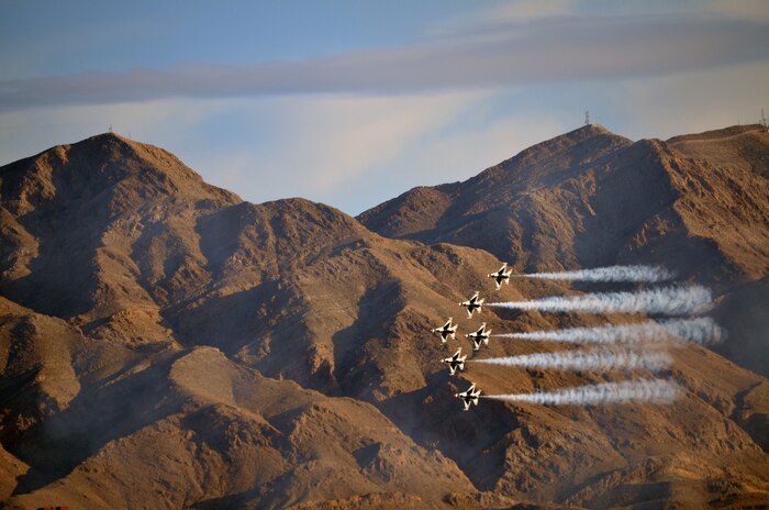 The Thunderbirds fly across a mountain range during their closing performance at Aviation Nation Nov. 12, 2011, at Nellis Air Force Base, Nev.  This photo won the Nellis Public Affairs photo contest, which judged the photos taken by Aviation Nation attendees.  (Photo by Jamie Quinlan) 