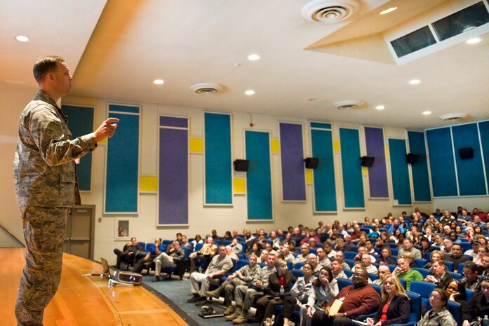 Col. Steve Garland, 99th Air Base Wing commander, addresses civilian employees during a Town Hall meeting Nov. 9, 2011, in the base theater at Nellis Air Force Base, Nev.  The purpose of this town hall was to discuss the recent Air Force announcement regarding the need to eliminate 4,500 civilian positions across the Air Force during the 2012 calendar year.  (U.S. Air Force photo by Lawrence Crespo/Released)