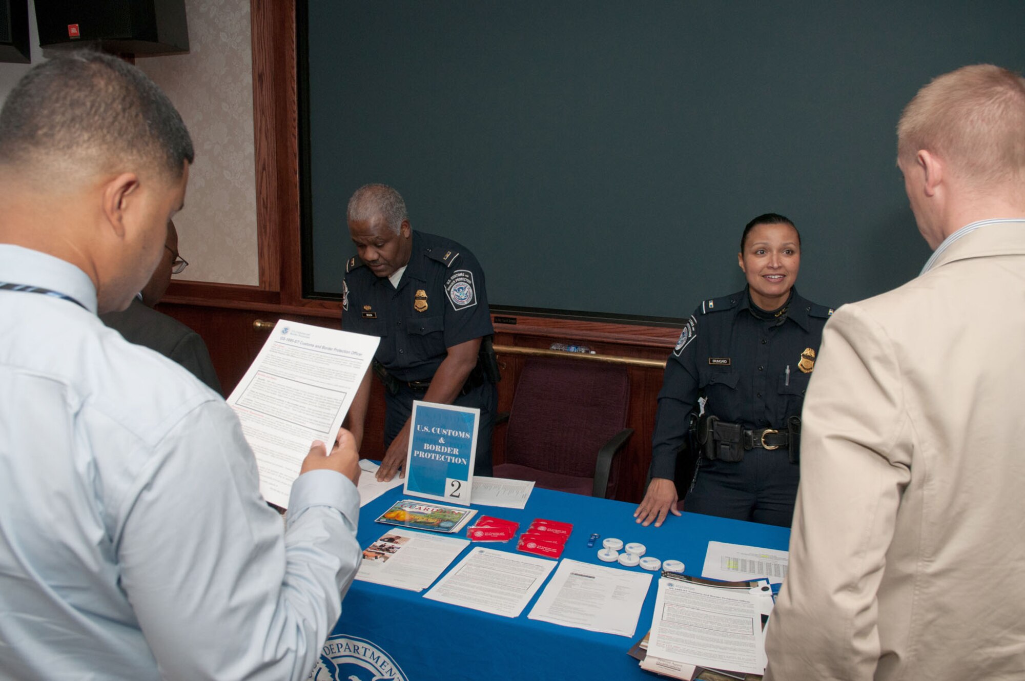 HANSCOM AIR FORCE BASE, Mass. – U.S. Customs and Border Protection agents speak to attendees during a job fair at the Hanscom Conference Center Nov. 10. More than 50 federal agencies and private sector companies attended the annual fair to recruit new employees. (U.S. Air Force photo by Rick Berry)
