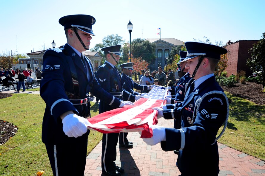 Members of the Seymour Johnson Air Force Base, N.C., honor guard fold the American flag in honor of Susie Stentors' father, Air Force Staff Sgt. Richard Petts, before the dedication of the Wayne County Veteran's Memorial in downtown Goldsboro, N.C., Nov. 11, 2011. Stentors asked the members of the honor guard to fold the flag in honor of her father who had passed away several years ago. (U.S. Air Force photo by Senior Airman Rae Perry)