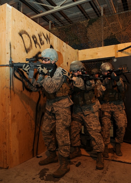 MINOT AIR FORCE BASE, N.D. -- Members of the 91st Security Forces Group tactical response team, engage in exercise clearing scenarios here Nov. 3. TRF is one of the most physically demanding jobs that security forces personnel can be a part of here. The 91st SFG has continued its ongoing effort of physical assessments designed to help their Airmen maintain full capability of their bodies throughout their Air Force careers. (U.S. Air Force photo/ Senior Airman Ashley N. Avecilla) 