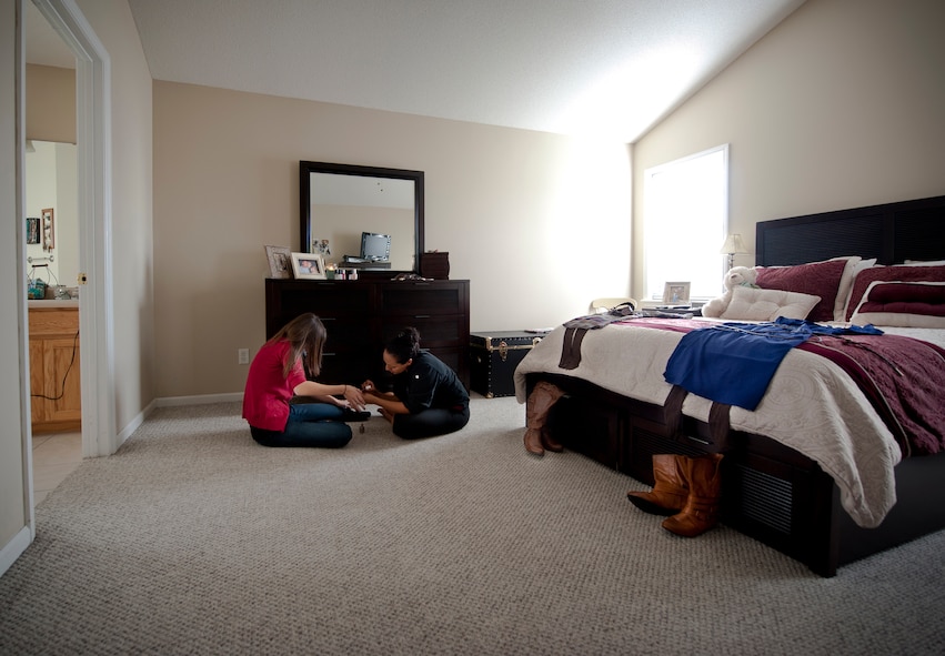 Kristen McSpadden, spouse of U.S. Air Force Capt. Cecil McSpadden, 822nd Base Defense Squadron officer in charge of intelligence, and 2nd Lt. Cara Bousie, 23rd Wing deputy chief of Public Affairs, paint each other’s nails as they prepare for their husbands’ deployment return in Valdosta, Ga., Nov. 12, 2011. McSpadden and Bousie waited six months for their husbands to return and were dressed to impress. (U.S. Air Force photo by Airman 1st Class Joshua Green/Released)              
        

