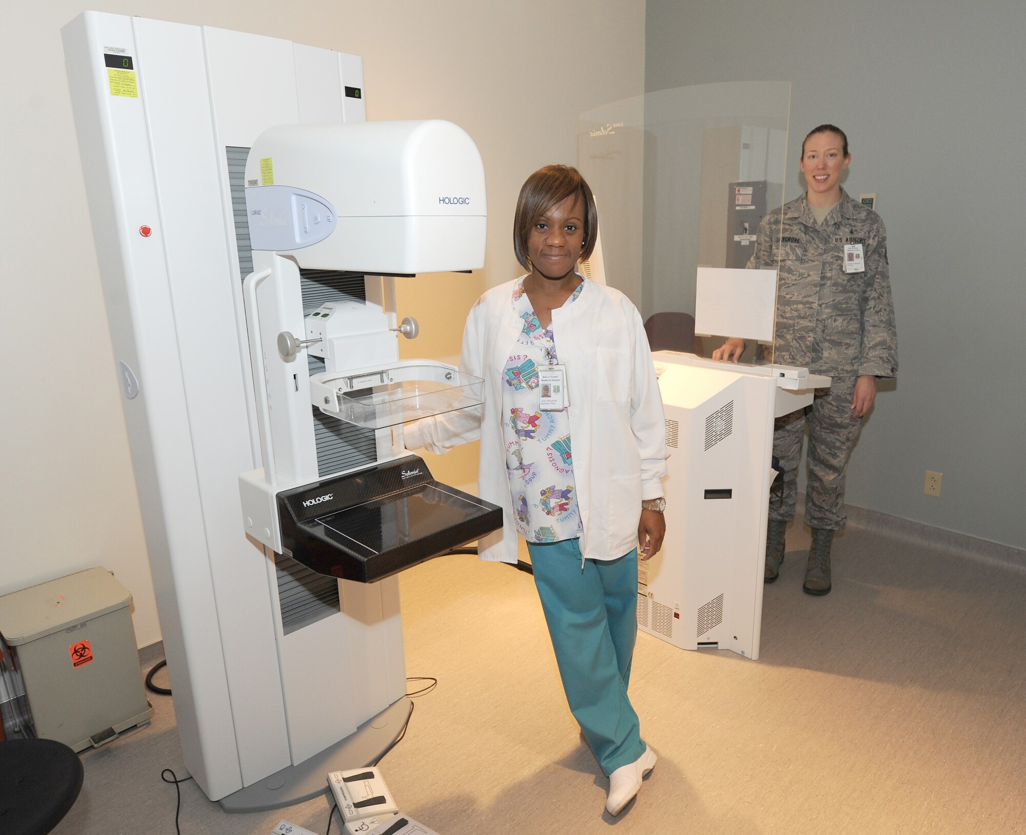 Ms. Roxanne Dyer and Staff Sgt. Catherine Hargrove, mammography technicians, demonstrate the leading edge digital mammography equipment at the David Grant USAF Medical Center. (U.S. Air Force photo/Staff Sgt. Liliana Moreno)