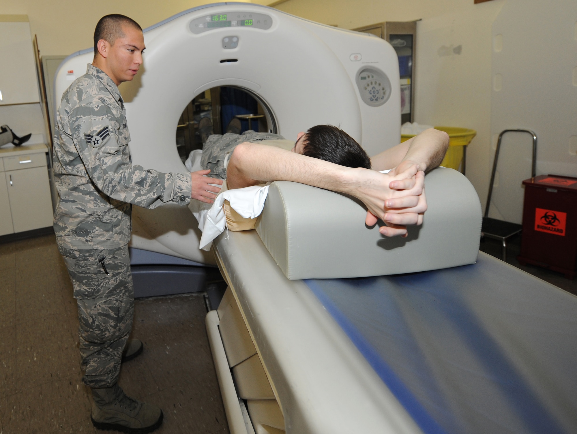 Senior Airman Freddy Toruno, computerized tomography technologist, performs a CT scan Nov. 9 at the David Grant USAF Medical Center. The CT scan creates several high-resolution images that are a cross-section of the scanned portion of the body; together these images provide accurate information about the patient's anatomy and tissue density.  (U.S. Air Force photo/Staff Sgt. Liliana Moreno)