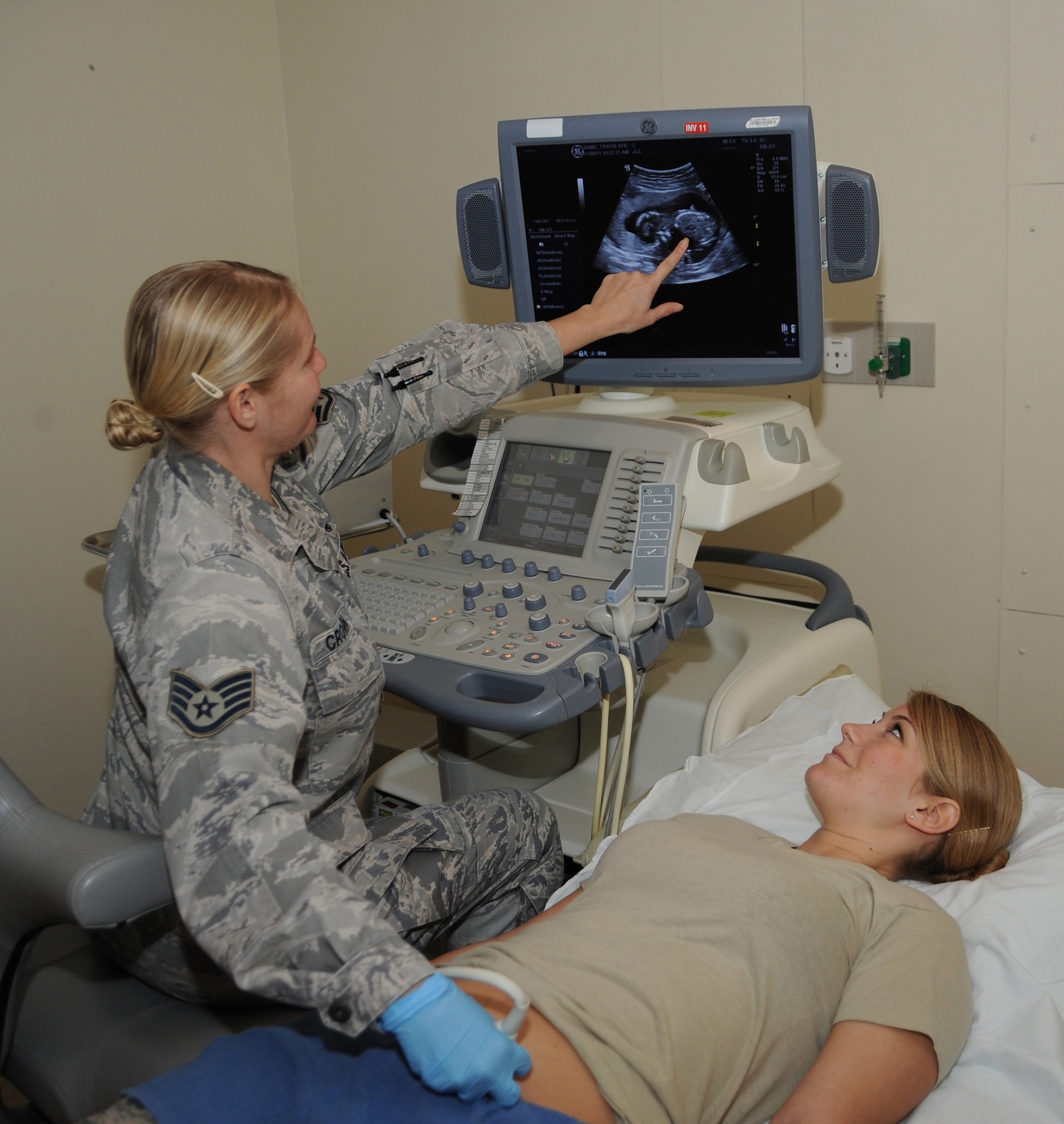Staff Sgt. Jenny Cronin, ultrasonographer, performs an ultrasound exam on SSgt Christine Ramirez Nov. 9 at the David Grant USAF Medical Center. Ultrasound images are captured in real-time; they can show the structure and movement of the body's internal organs, as well as blood flowing through blood vessels. (U.S. Air Force photo/Staff Sgt. Liliana Moreno)