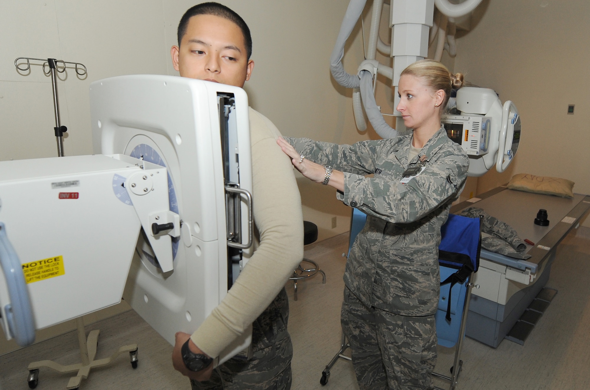 Airman 1st Class Celisse Smith, diagnostic imaging technologist, positions A1C Erick Alvarez for an x-ray exam Nov. 9 at the David Grant USAF Medical Center.  (U.S. Air Force photo/Staff Sgt. Liliana Moreno)