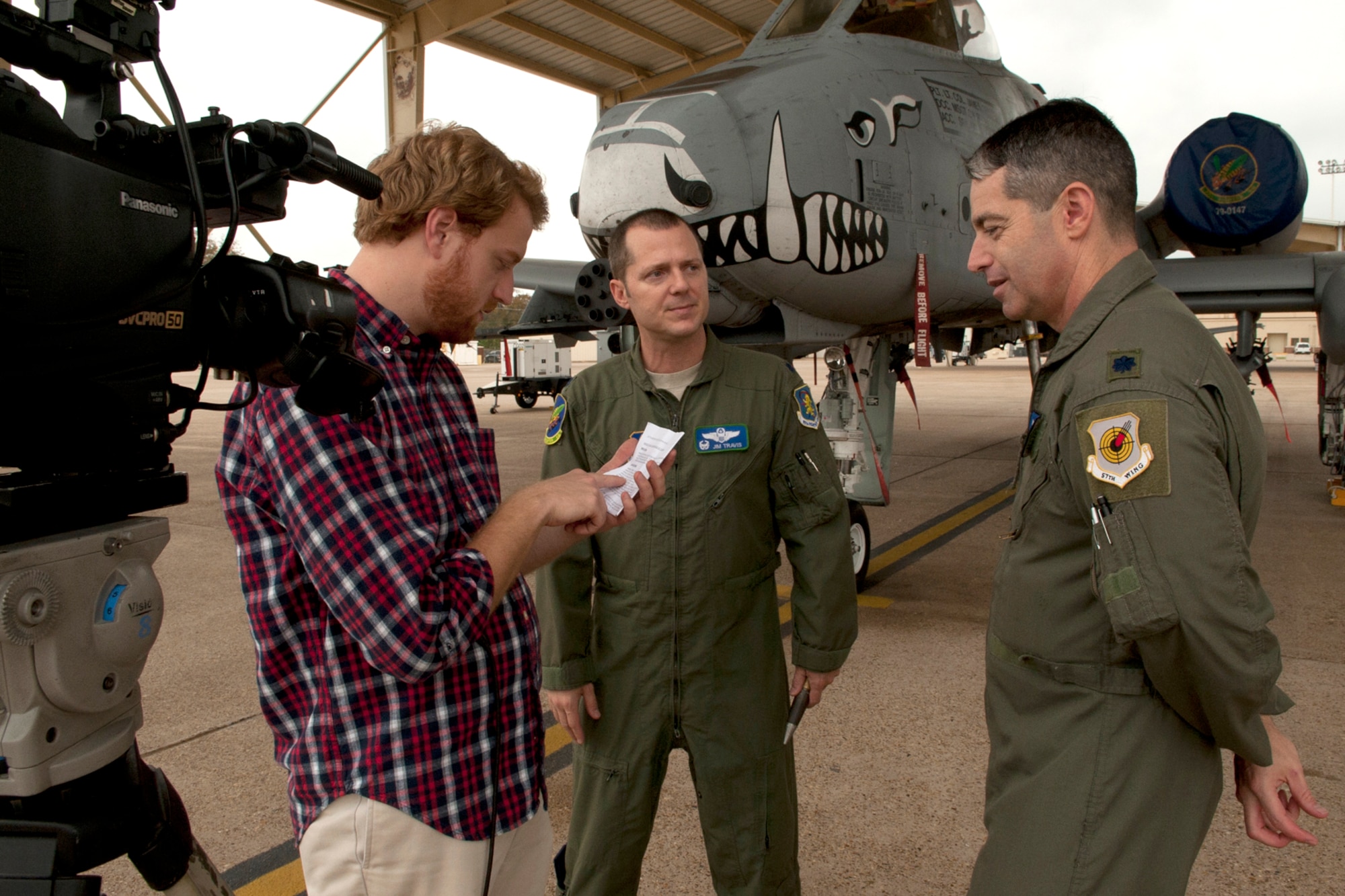 Paul Sweazy, KTAL Channel 6 photojournalist, goes over interview questions with Lt. Cols. James Travis, 47th Fighter Squadron commander, and Patrick McKeever, 548th Combat Training Squadron/Detachment 1 commander, for a Barksdale Profile segment on the Green Flag exercise at Barksdale Air Force Base, La., Nov. 15, 2011. Green Flag exercises provide realistic close-air-support training for tactical aircrews and tactical air control parties at the U.S. Army Joint Readiness Training Center at Fort Polk, La. (U.S. Air Force photo by Master Sgt. Greg Steele/Released)