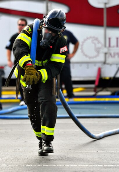 Staff Sgt. Steven Thomas, 20th Civil Engineer Squadron firefighter, drags the hose during his individual race at the Scott Firefighter Combat Challenge world competition at Myrtle Beach, S.C., Nov. 15, 2011. Last year the Shaw firefighter five-man relay placed in the top ten percent in the world. (U.S. Air Force photo/Airman 1st Class Daniel Phelps/Released)
