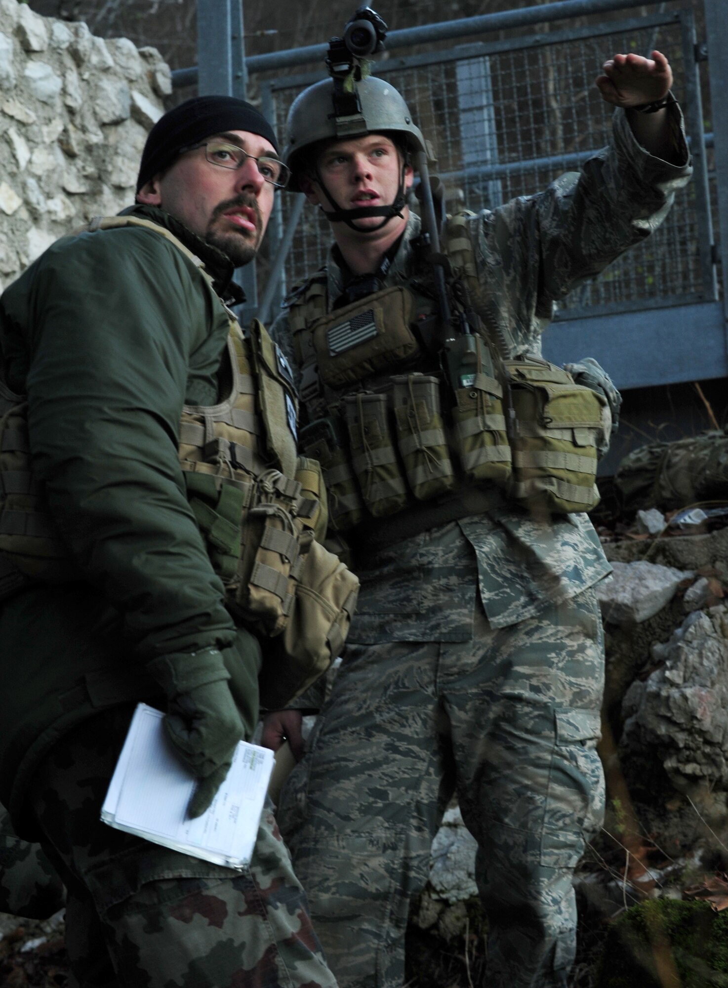 (From left) Peter Sojer, Slovenian TACP group, watches as Senior Airman Eric Gray, 8th Air Support Operations Squadron air control party operator, explains where a simulated target is located. Gray participated in a NATO Coalition training to help refine their techniques and procedures of tactical command and control of air power assets. (U.S. Air Force photo/Airman 1st Class Briana Jones)


