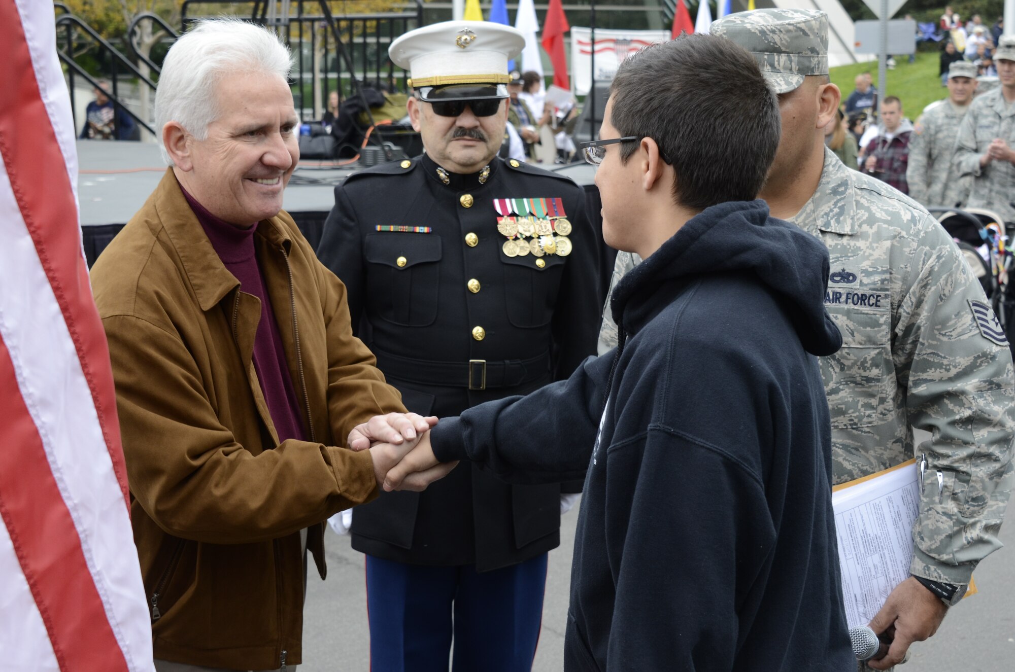 Congressman Jim Costa, 20th District, shakes the hand of the 144th Fighter Wing's newest recruit, Joshua De Leon.  Joshua enlisted into the Calif. Air National Guard on Nov. 11, 2011 prior to the start of the largest Veterans Day Parade west of the Mississippi.  (U.S. Air Force photo by SMSgt. Chris Drudge)