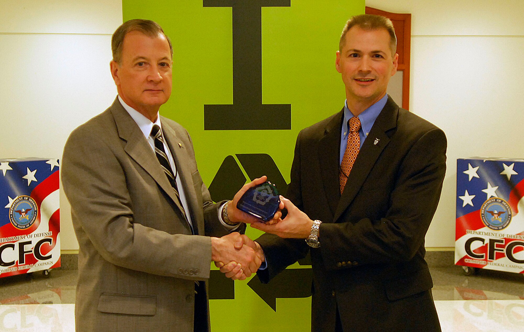Dr. Kevin Geiss, the deputy assistant secretary of the Air Force for energy, accepted the Pentagon's Green Award on behalf of the Air Force Energy Office from the Pentagon's Director of Facilities Bradley Provancha during the Pentagon’s "America Recycles Day" event in Washington on Nov. 15, 2011. (U.S. Air Force photo/Tech. Sgt. Richard Williams)