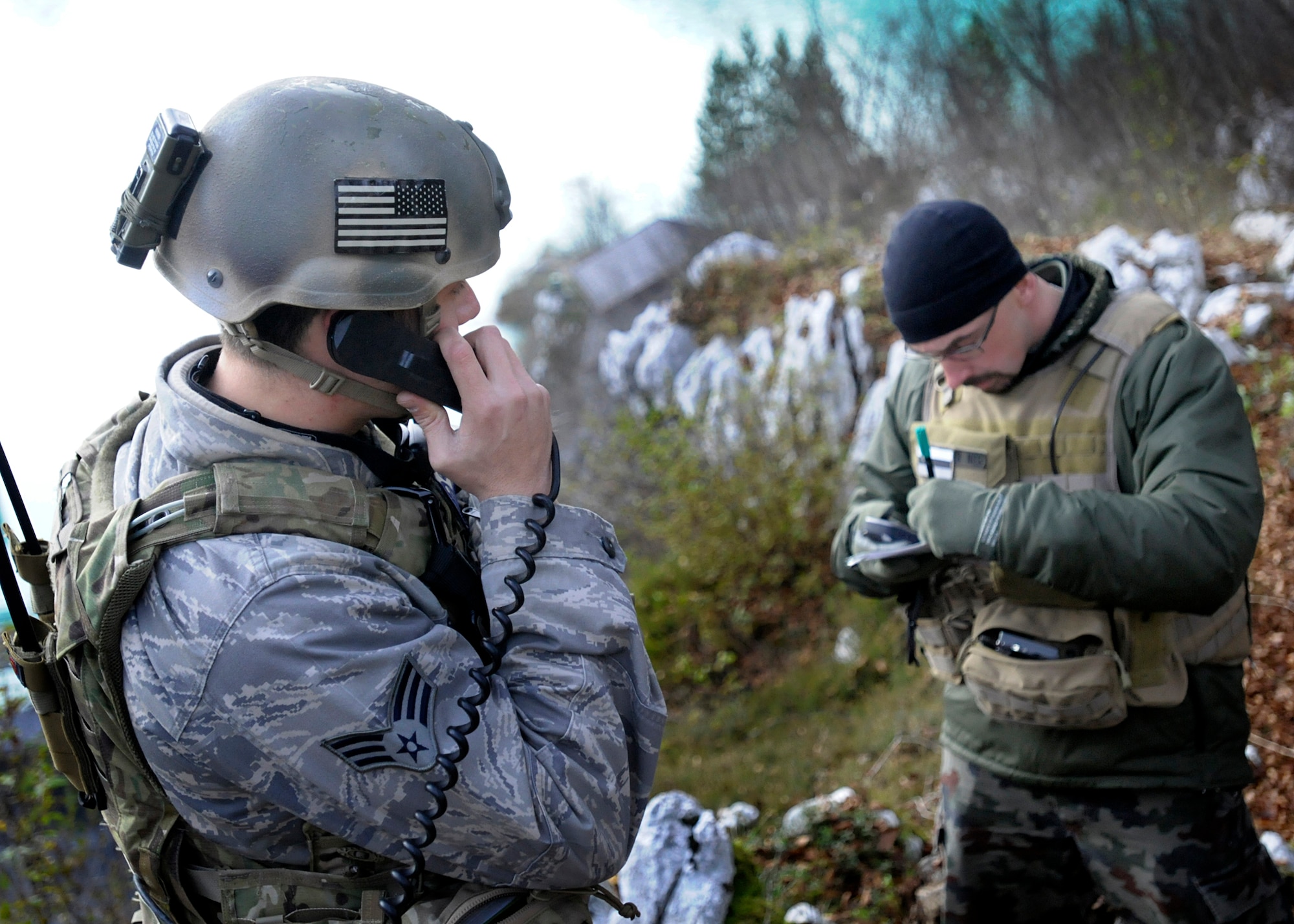 (From Left)  Senior Airman Brad Salazar, 8th Air Support Operations Squadron tactical air control party operator, and Peter Sojer, Slovenian TACP group, call a simulated air assault in Barcis, Italy, Nov. 15.  The 8th ASOS participated in NATO coalition training to help refine techniques and procedures of tactical command and control of air power assets.  (U.S. Air Force photo/Senior Airman Evelyn Chavez)