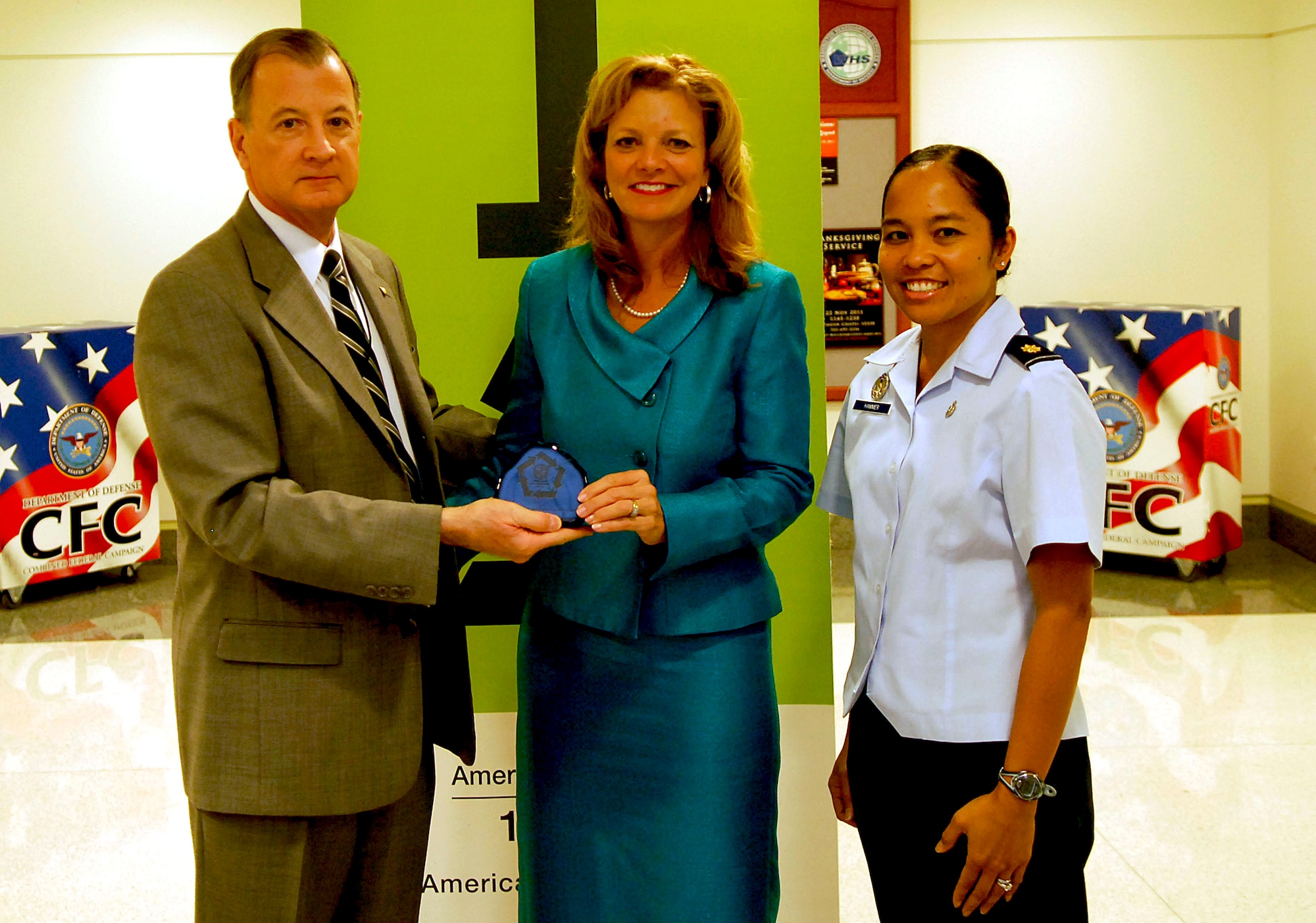 During the Pentagon’s "America Recycles Day" event in Washington on Nov 15., 2011, Debra Tune, the principal deputy assistant secretary of the Air Force for installations, environment and logistics, and Maj. Elisa Hammer, of the Office of the Deputy Assistant Secretary of the Air Force for Environment, Safety and Occupational Health, accepted the Pentagon's Green Award on behalf of the Air Force's Installations, Environment and Logistics Office from the Pentagon's Director of Facilities Bradley Provancha. (U.S. Air Force photo/Tech. Sgt. Richard Williams)