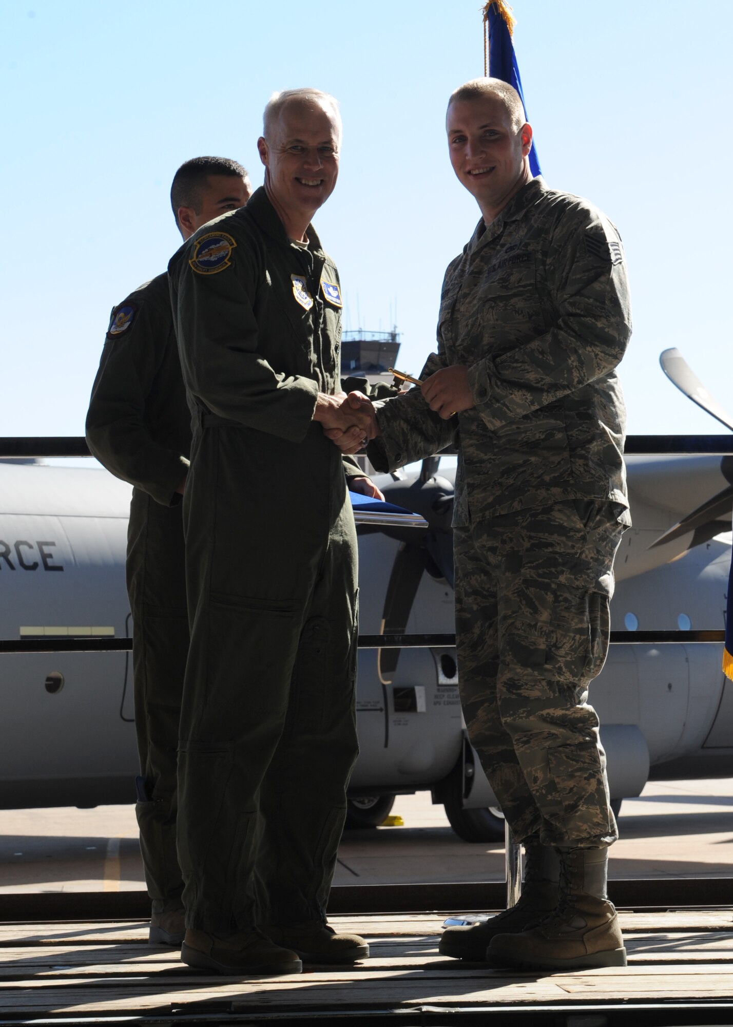 Lt. Gen. Richard Newton lll, Assistant Vice Chief of Staff, presents Staff Sgt. Scott Esler, 317th Aircraft Maintenance Sqaudron, the honorary key at the C-130 J-model number 11 arrival, Nov. 15, 2011, at Dyess Air Force Base, Texas. The aircraft is the 11th of 28 to be delivered to Dyess by 2013, replacing the current aging fleet of C-130 H-models. (U.S. Air Force photo by Airman 1st Class Jonathan Stefanko/ Released)  