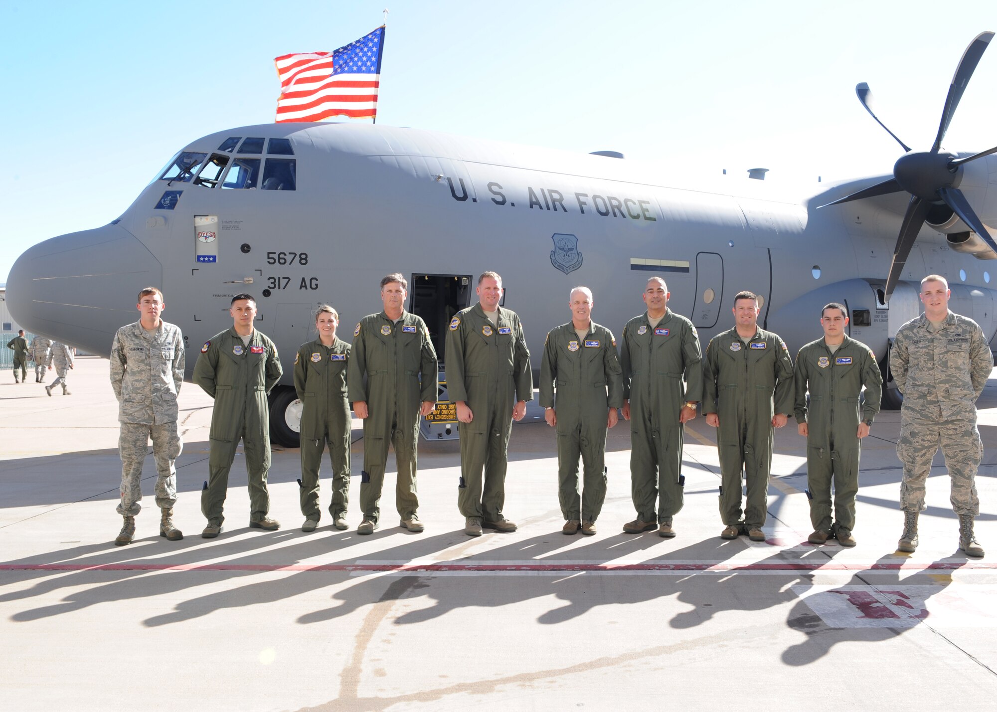 The crew of a new C-130 J-model gathers outside the aircraft Nov. 15, 2011, at Dyess Air Force Base, Texas. The aircraft is the 11th of 28 to be delivered to Dyess by 2013, replacing the current aging fleet of C-130 H-models. (U.S. Air Force photo by Airman 1st Class Jonathan Stefanko/ Released) 