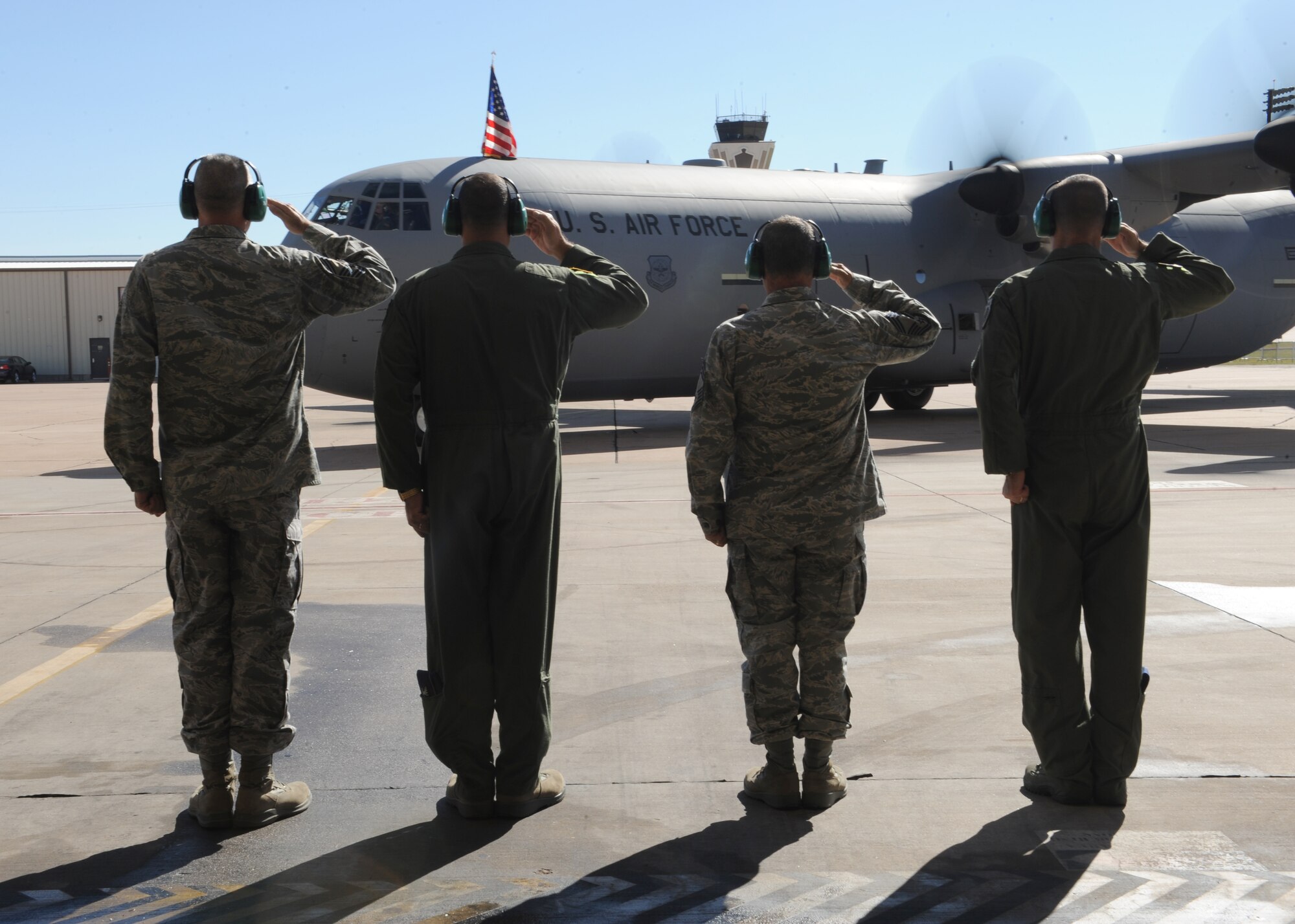 Dyess leadership renders a salute as a new C-130 J-model passed Nov. 15, 2011, at Dyess Air Force Base, Texas. The aircraft is the 11th of 28 to be delivered to Dyess by 2013, replacing the current aging fleet of C-130 H-models. (U.S. Air Force photo by Airman 1st Class Jonathan Stefanko/ Released)  