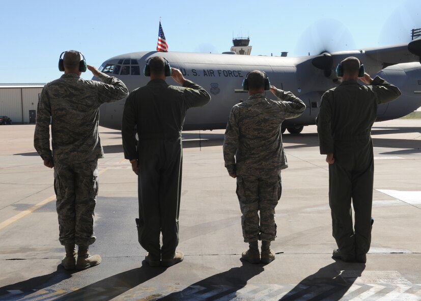 Dyess leadership renders a salute as a new C-130 J-model passed Nov. 15, 2011, at Dyess Air Force Base, Texas. The aircraft is the 11th of 28 to be delivered to Dyess by 2013, replacing the current aging fleet of C-130 H-models. (U.S. Air Force photo by Airman 1st Class Jonathan Stefanko/ Released)  