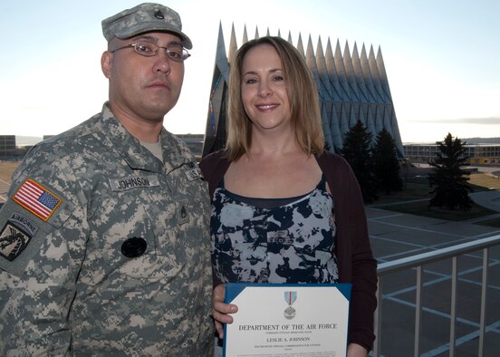 Leslie Johnson, right, poses for a photograph with her husband, Army Staff Sgt. Jeremiah Johnson, near the Air Force Academy's Cadet Chapel Nov. 16, 2011. Johnson received a Command Civilian Award for Valor from Academy Superintendent Lt. Gen. Mike Gould for placing herself in harm's way to rescue a 21-year-old resident of Colorado Springs, Colo., on Aug. 10. (U.S. Air Force photo/Don Branum)