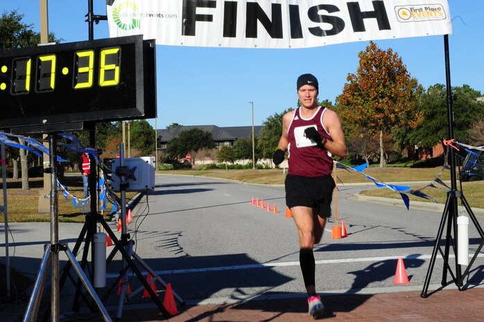Twenty six year old Nate Bergeron from Charleston runs across the finish line first with a time of 17:36 during the  third annual Run the Runway 5K event honoring Brig. Gen. Thomas Mikolajcik Nov. 11 at Joint Base Charleston - Air Base. The 5k course took place on JB Charleston's runway.  The event was held to raise awareness of Amyotrophic Lateral Sclerosis.  (U.S. Air Force photo/Tech. Sgt. Chrissy Best) 

