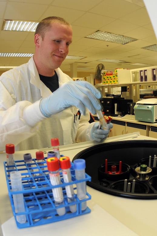 Petty Officer 3rd Class Matthew Hampton places a water vial in the centrifuge prior to running the machine. The vial filled with water acts as a balancer ensuring no displacement while the machine runs. The machine is used to separate the red blood cells from the serum in the blood. The liquid excreted is what is tested by lab technicians. Hampton is a Hospital Corpsman at Naval Health Clinic Charleston. (U.S. Navy photo/Petty Officer 1st Class Jennifer Hudson)