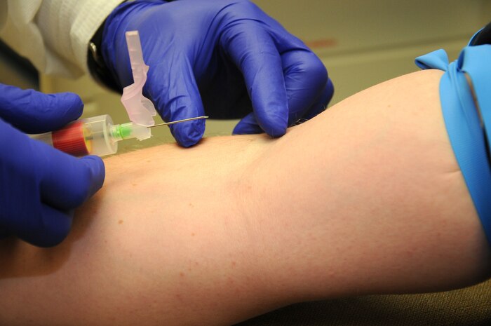Petty Officer 1st Class Tony Garrett readies a needle to collect blood samples from a patient at Naval Health Clinic Charleston. Garrett is a Hospital Corpsman at NHCC. (U.S. Navy photo/Petty Officer 1st Class Jennifer Hudson)