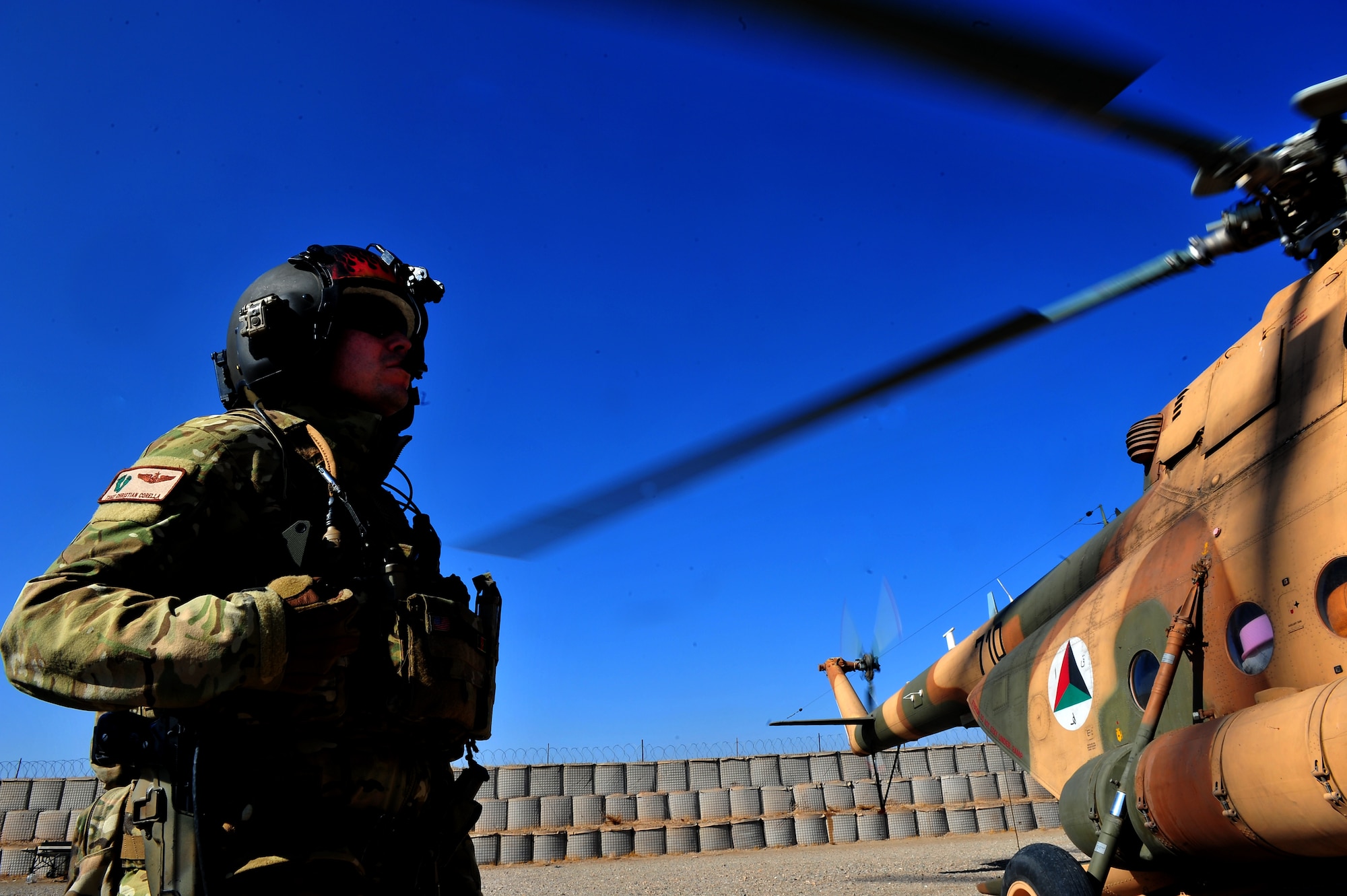 Tech. Sgt. Christian Corella, 838th Air Expeditionary Advisory Group aerial gunner adviser, ensures the Mi-17 helicopter engines are good to go for an emergency resupply flight through western Afghanistan, Nov 11, 2011. The U.S. and Afghan flight crews provided supplies to a remote Afghan Border Patrol outpost. Airmen advise Afghan soldiers on maintenance, operations, flight, and security of the Mi-17 helicopter. Corella is deployed from the 88th Test and Evaluation Squadron at Nellis AFB, Nev., and a native of El Paso, Texas. (U.S. Air Force Photo/SrA Tyler Placie)