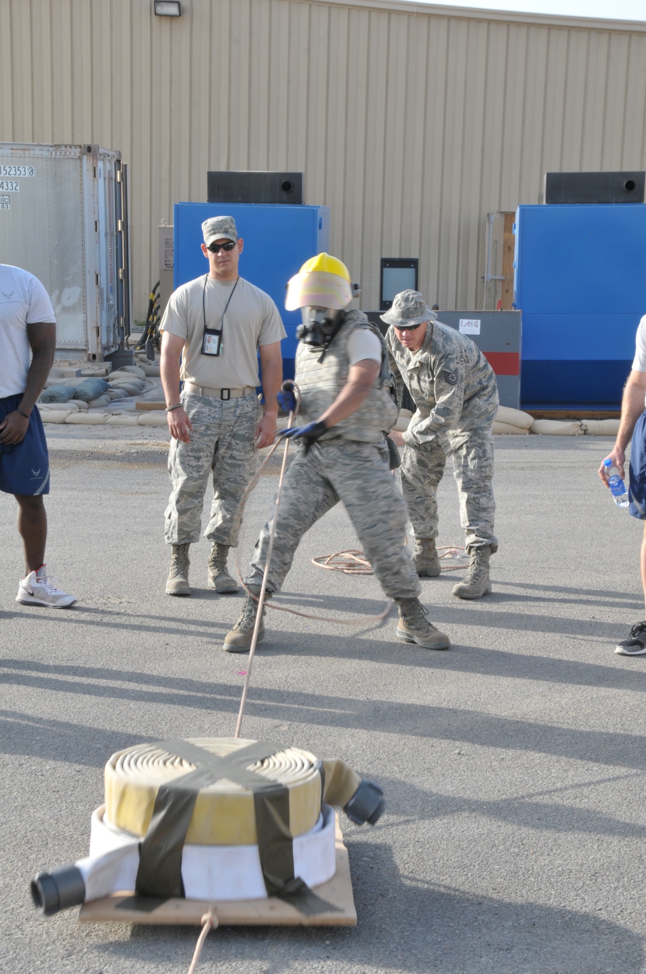Senior Airman Michael Pagan, 332nd Expeditionary Civil Engineer Squadron firefighter, pulls 50 pounds of fire hoses and platform to imitate pulling the hoses during an actual fire, as part of a firefighter challenge at an undisclosed location in Southwest Asia Nov. 11, 2011. Pagan, who is from Lewisberry, Pa., and is deployed from Joint Base McGuire-Dix-Lakehurst, N.J., and was one of several 332nd Air Expeditionary Wing Airmen who participated in the challenge to commemorate Veterans Day. (U.S. Air Force photo by Master Sgt. Paul Mann)