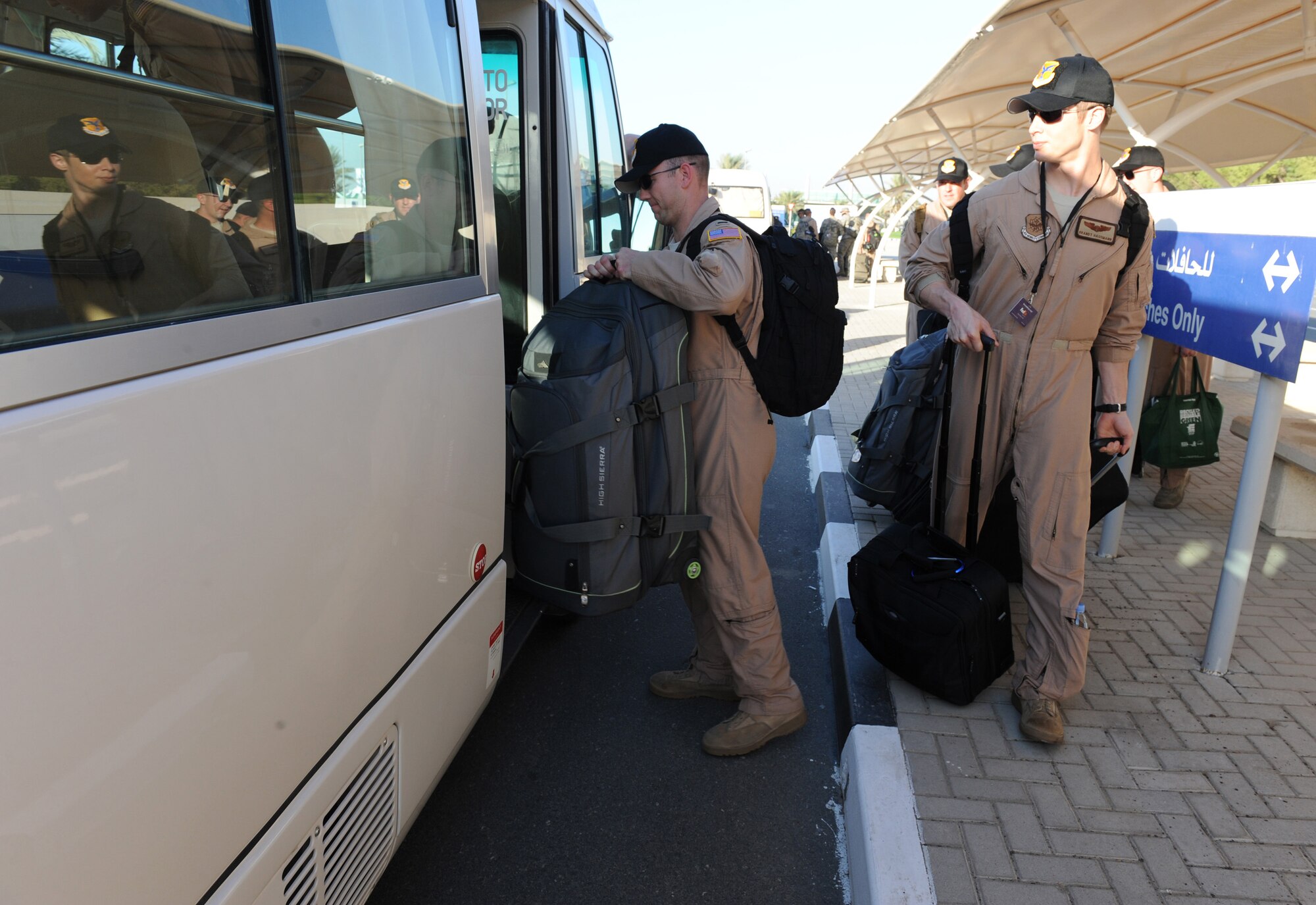 Several Airmen load up a bus Nov. 12, 2011, that is leaving the site of the Dubai Airshow 2011. A small group of Airmen from the 380th Expeditionary Logistics Readiness Squadron forward deployed to the air show to provide transportation to all Department of Defense personnel at the air show. The U.S. is participating in the air show to enhance interoperability and demonstrate a shared commitment to regional security and stability.  (U.S. Air Force photo/Master Sgt. Chance Babin)