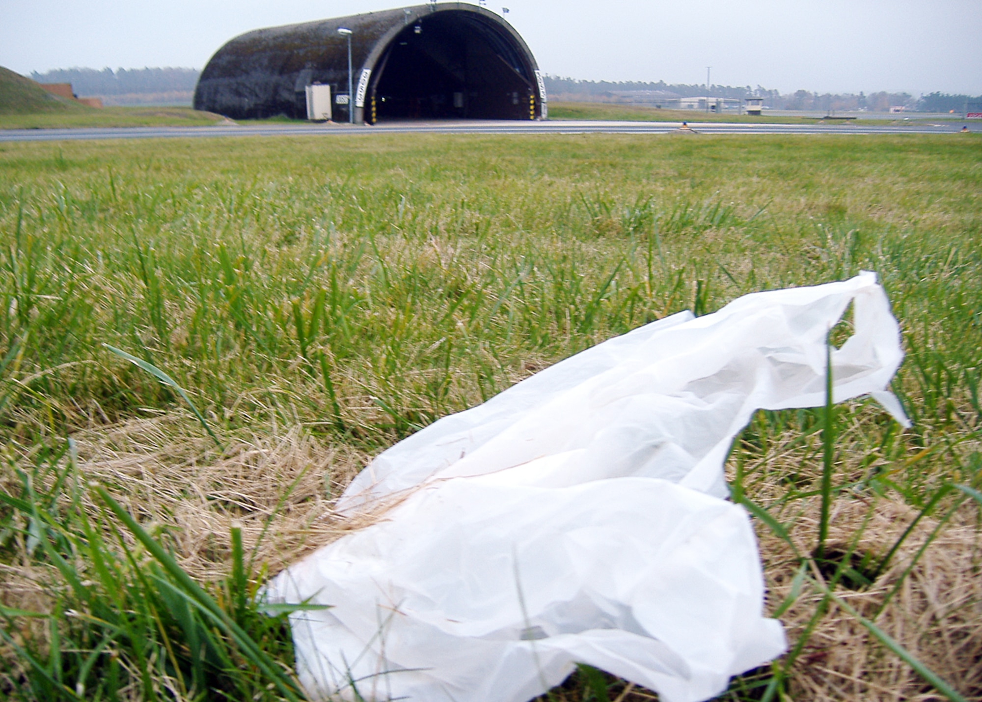 SPANGDAHLEM AIR BASE, Germany – A plastic bag rests in the grass near the flightline here Nov. 8. Foreign object debris like this can damage government equipment. The 52nd Fighter Wing’s foreign object damage manager, in collaboration with base civilian agencies, provided re-usable grocery bags to Airmen and their families at the commissary in an effort to enhance recognition of the dangers loose debris have on the base’s flying mission. (U.S. Air Force photo/Master Sgt. Matthew LaNew)