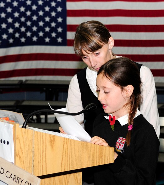RAF FELTWELL, England – Lauren Preston, 10, a student from Feltwell Primary School, reads a letter her great-great-grandfather wrote to his wife the night before his ship was sunk during World War I. Lauren was assisted by Caroline Wakefield, Feltwell Primary School teacher, who also shared a story about her family’s loss in World War II. (U.S. Air Force photo/Senior Airman Ethan Morgan)