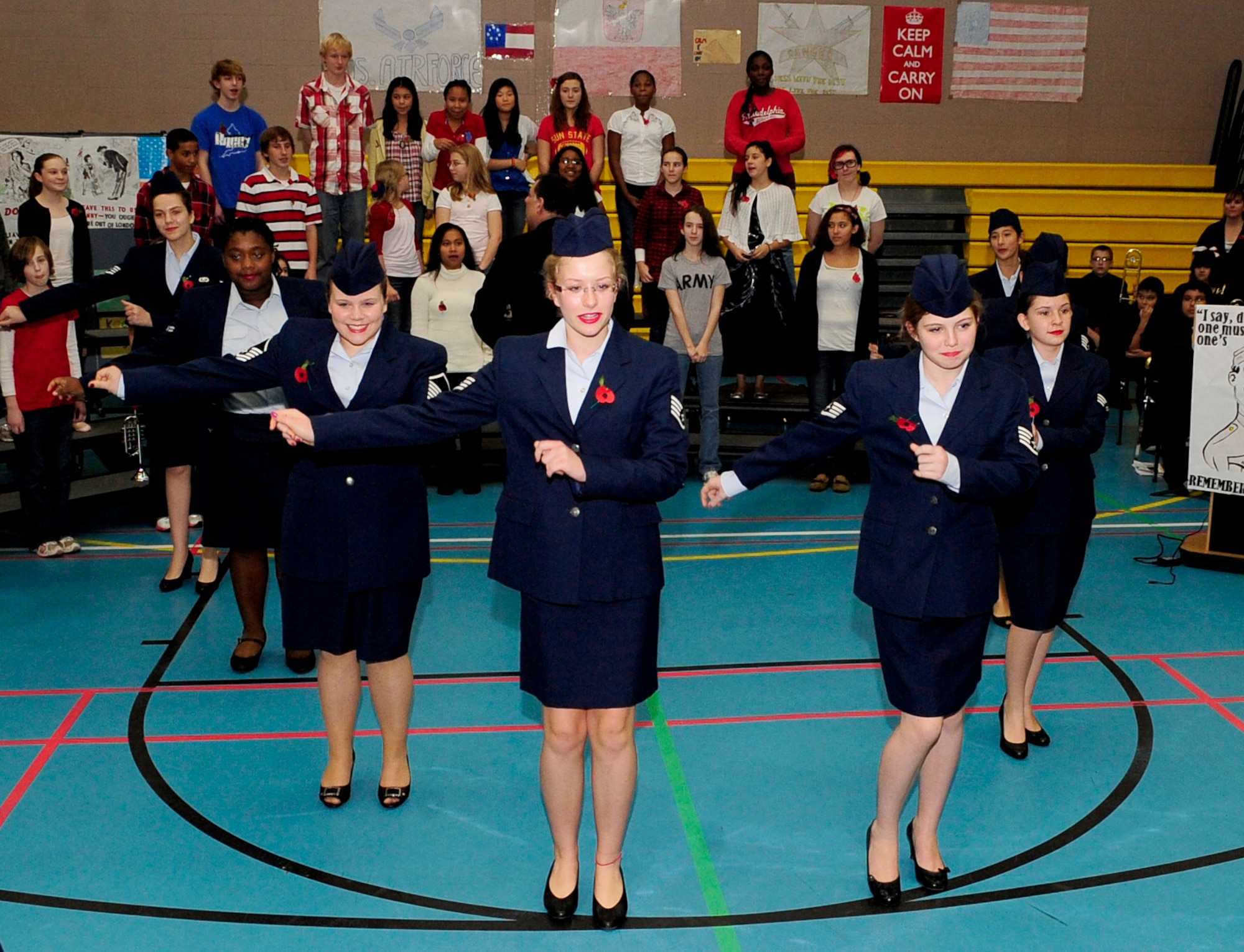 RAF FELTWELL, England – Boogy Woogy Bugle Girl dancers from RAF Feltwell Middle School perform during a Remembrance Day event at their school Nov. 9, 2011. The event consisted of singing, dancing, guest speakers and a blackout, to simulate the real-world blackouts in England during World War II. (U.S. Air Force photo/Senior Airman Ethan Morgan)