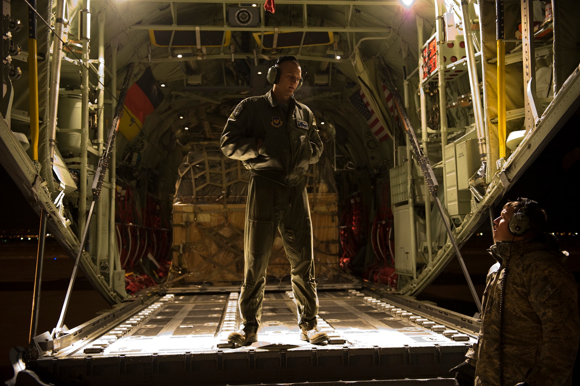 Airman 1st Class Christopher Dysert and Staff Sgt. Glen Scott both from the 37th Airlift Squadron, Ramstein Air Base, Germany talk about the mission while waiting to unload C-130J Hercules aircraft with pallets of humanitarian supplies from Stjordal, Norway, Nov. 15. The effort is in support of the Turkey-led relief efforts following the Nov. 9, and Oct. 23, earthquake in Van province, Turkey. At the request of the Turkish government the Department of Defense has tasked U.S. European Command to airlift relief supplies to Van province.  (U.S. Air Force photo/MSgt Wayne Clark, AFNE Regional News Bureau) (Released)