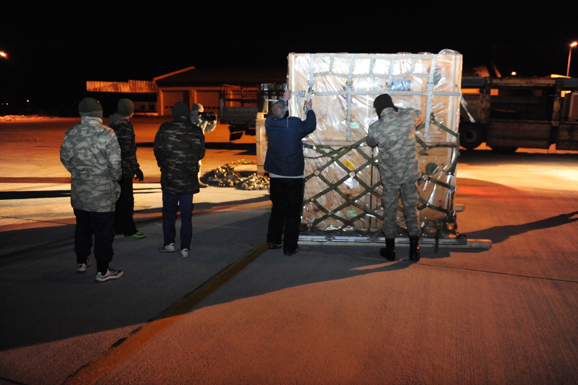Turkish civilian and military personnel unload pallets of supplies and equipment off a C-130 in Van province, Turkey on Nov. 14. The pallets were flown to Turkey via a C-130J Hercules ???Christine??? to assist in humanitarian relief efforts in the aftermath of two major earthquakes that struck the country. (U.S. Army photo by Spc. Jason A. Blackburn/Released)
