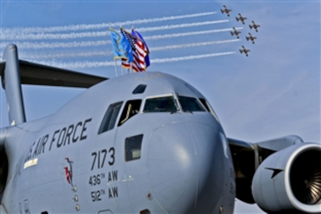 An aerobatic team flies over a U.S. Air Force C-17 Globemaster during the Dubai Air Show 2011 Airport Expo in Dubai, United Arab Emirates, Nov. 13, 2011. This year the static displays from the United States will be the B-1B Lancer, C-17 Globemaster, C-130 Hercules, E2-C Hawkeye, F-15C Eagle, F-16 Fighting Falcon, F-18 Hornet, MH-60R Seahawk, and V-22 Osprey. The event demonstrates a shared commitment both to regional security and to developing our key relationships throughout Southwest Asia.