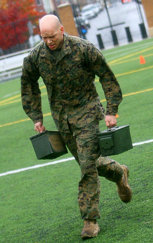 Capt. Matthew Bartels, the Marine Barracks Washington training officer, dashes to the finish line while carrying two 30-pound ammo cans during the Ammo Can Decathlon here Nov. 16. The course was identical to the combat fitness test, where Marines run 880 yards, perform ammo can lifts and maneuver through cones for time and score. The competition was the last scheduled event of the Barracks’ 2011 Commander’s Cup series.