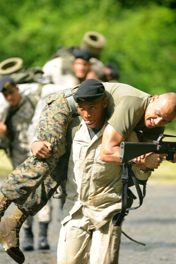 A Dominican Republic Marine carries Hospitalman 3rd Class Cpl. Jorge Juarez, assigned to the Marine detachment of High Speed Vessel (HSV 2) Swift, while practicing a fireman's carry.  The two Marine Corps are participating in a three week partnership as part of Southern Partnership Station (SPS) 2012. SPS is an annual deployment in the U.S. Southern Command's Area of Responsibility, partnering the Caribbean and Latin America.