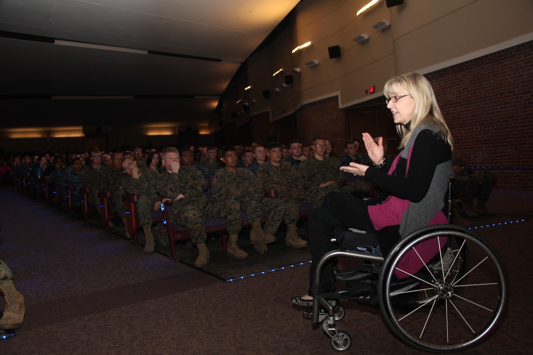 Kelly Narowski, a certified safety teacher, stresses the importance of safe driving habits during her presentation at the Cherry Point theater Nov. 17. Narowski became a paraplegic in her twenties as a result of drinking and driving, and not wearing a seatbelt. She used hers and others examples of what can go wrong if people follow poor habits. She stressed the importance of buckling up, not driving while distracted by calls, food or makeup and not driving while tired. One of the core tenets of her safety message was any distraction puts the driver at risk of making a deadly mistake. Narowski said that she understands the strain put on military personnel because she is married to a soldier. Even with this strain, though, service members still need to drive safely by eliminating bad habits and making good ones.
