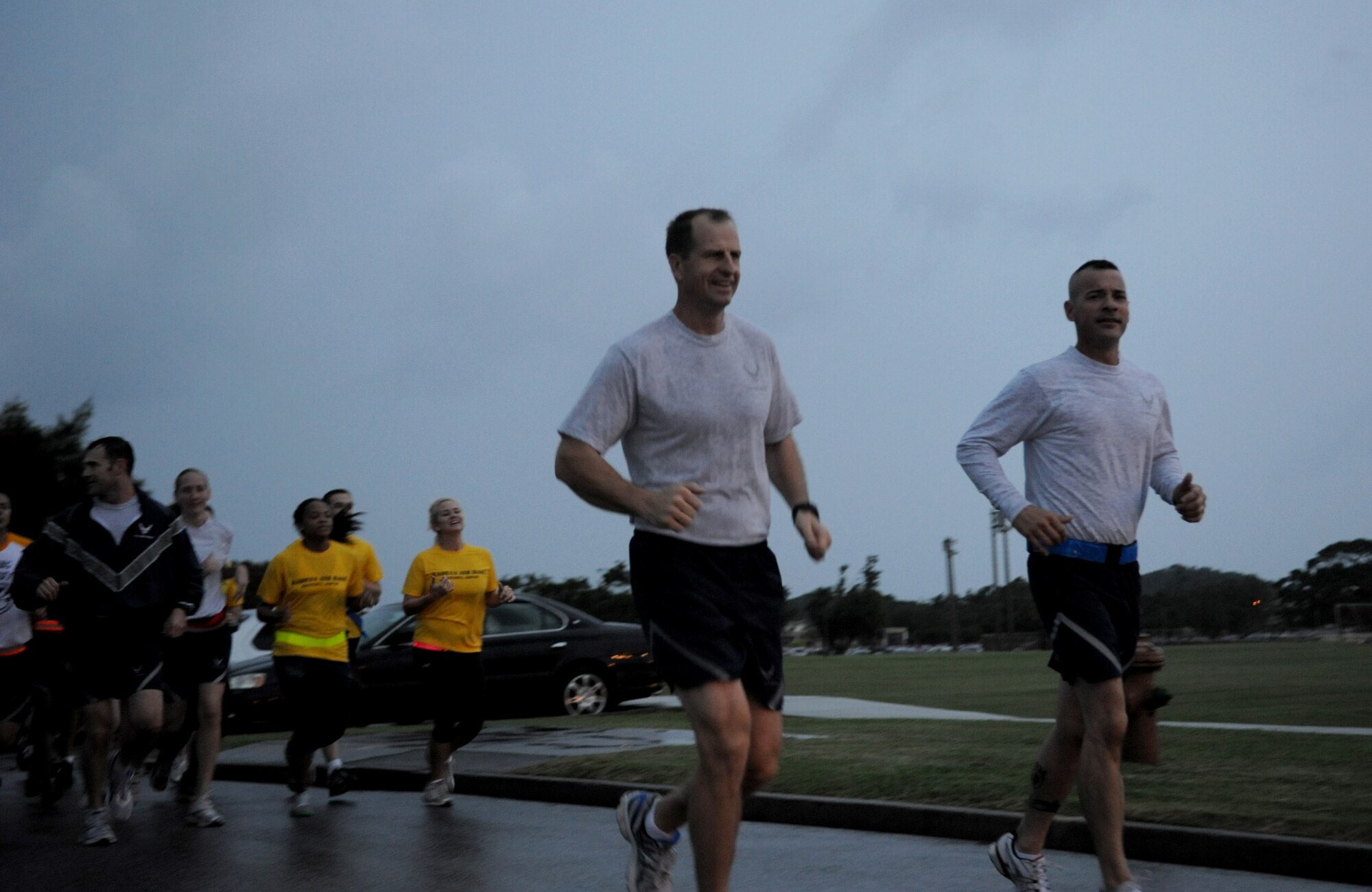 U.S. Air Force Col. Corey Martin, 18th Wing vice commander, and U.S. Air Force Chief Master Sgt. Mark Marson, 18th Wing command chief, lead the formation during the Wingman Day run on Kadena Air Base, Japan, Nov. 18, 2011. Wingman Day is designed to improve the resiliency of individuals through structured discussion in small groups and team-building exercises at the squadron level. (U.S. Air Force photo/Senior Airman Jarvie Z. Wallace/Released)