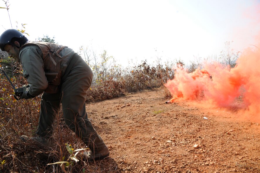 Maj. Jared Johnson, 8th Operations Group chief of standards and evaluations and F-16 pilot, sets a flare for aerial identification and pick-up at his designated zone during a Peninsula-wide Operational Readiness Exercise in Jeongan-myeon, Republic of Korea, on Nov. 16, 2011.  He simulated a downed pilot in his scenario. His scenario was one of the many during the PENORE to prepare the Wolf Pack for wartime contingencies and their operational readiness inspection. (U.S. Air Force photo by Staff Sgt. Rasheen Douglas/Released)