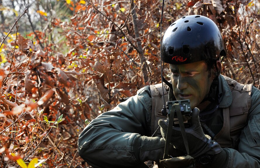 Maj. Jared Johnson, 8th Operations Group chief of standards and evaluations and F-16 pilot, radios in after reaching his designated zone to be picked up during a Peninsula-wide Operational Readiness Exercise in Jeongan- myeon, Republic of Korea, on Nov. 16, 2011.  He simulated a downed pilot in the scenario. His scenario was one of the many during the PENORE to prepare the Wolf Pack for wartime contingencies and their operational readiness inspection. (U.S. Air Force photo by Staff Sgt. Rasheen Douglas/Released)