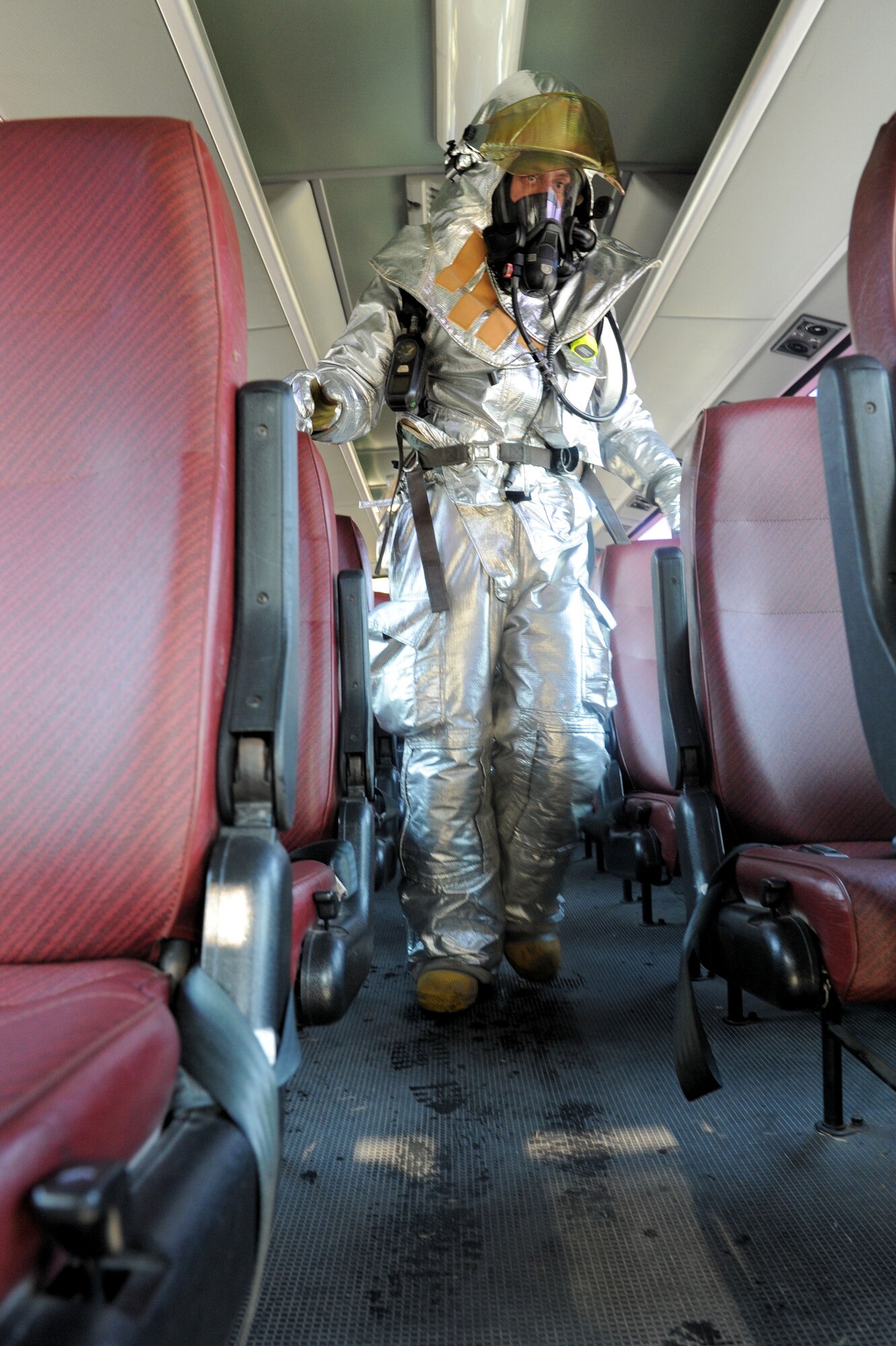 A firefighter with the 8th Civil Engineer Squadron exits a bus after checking for survivors and victims during an exercise scenario Nov. 16, 2011, as part of operational readiness exercise Beverly Bulldog 11-3. The scenario was planned and evaluated by several exercise evaluation team members who tested Airmen’s ability to quickly and safely respond to the incident. As part of the scenario, opposition forces ambushed the bus and caused it to crash into the base post office. The exercise is part of a peninsula wide operation, which tests Airmen and Soldiers' ability to respond and defend the area during wartime conditions. (U.S. Air Force photo by Senior Airman Jessica Hines/Released)