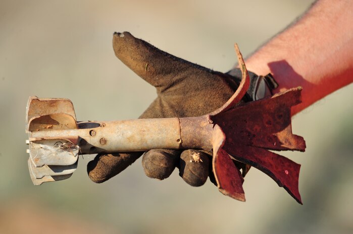 Stephen Baker, URS Corporation supervisor, displays an exploded 1946 era 81mm HE mortar at Beale Air Force Base, Calif., November 16, 2011, which was the former Camp Beale. The ordinance was found in a retired bombing range used for training during and after World War II. (U.S. Air Force photo by Airman 1st Class Shawn Nickel/Released)