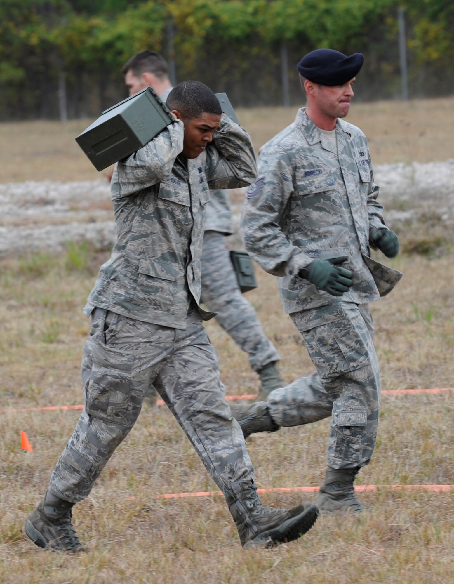 CAMP MINDEN, La. - Staff Sgt. Michael Boutte, Jr., 509th Security Forces Squadron, carry two ammunition cans to the finish line during the physical portion of the mental and physical challenge for the second annual Global Strike Challenge at Campt Minden, La., Nov. 7. The physical portion consists of low and high crawls, a buddy drag, a fireman's carry and an ammunition can carry run. (U.S. Air Force photo/Staff Sgt. Alexandra M. Boutte) (RELEASED)