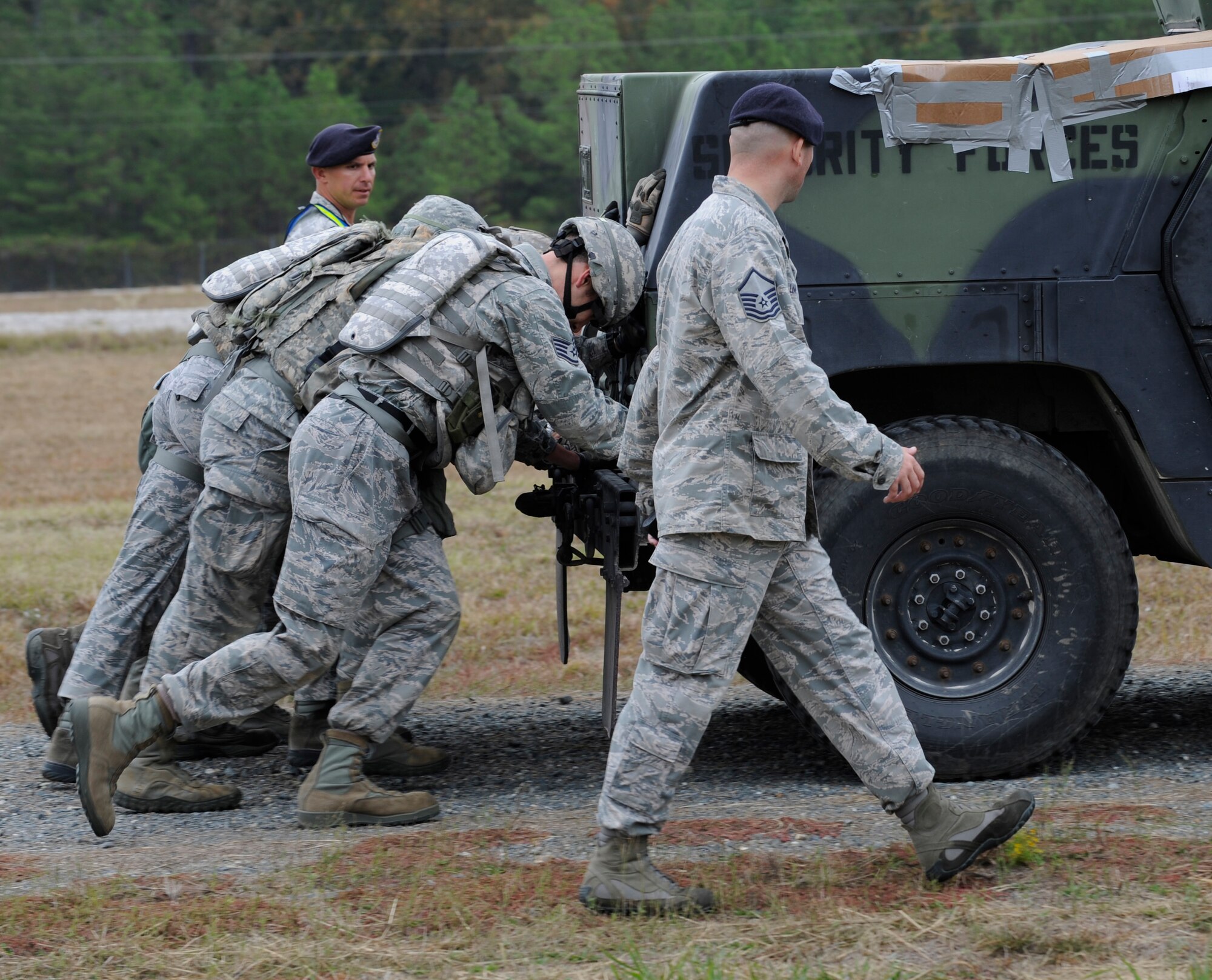 CAMP MINDEN, La. - The 509th Security Forces Squadron pushes the up-armored Humvee down a stretch of road during a phase of the mental and physical challenge of the second annual Global Strike Challenge at Camp Minden, La., Nov. 7. The Humvee is a 2-ton armored, deployed tactical vehicle. The competition includes security forces along with missile and bomber forces from Air Force Global Strike Command. The teams have the opportunity to participate in innovative thinking, teamwork and esprit de corps that are central to the GSC mission. (U.S. Air Force photo/Staff Sgt. Alexandra M. Boutte) (RELEASED)