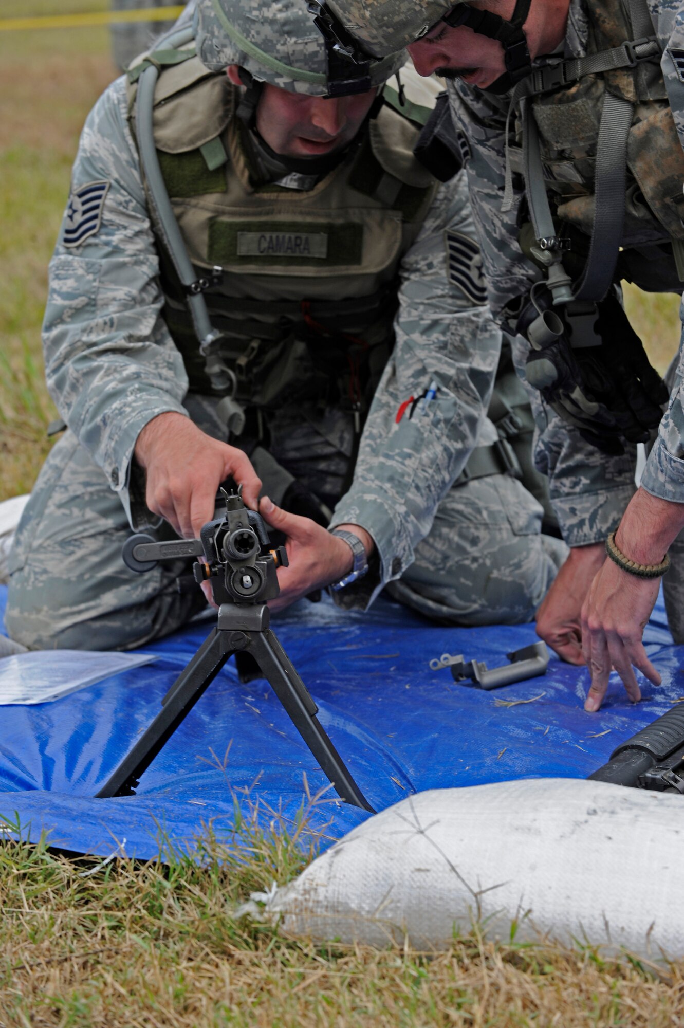 CAMP MINDEN, La. - Tech. Sgt. Chris Camera and Senior Airman James Doan, 509th Security Forces Squadron assemble a M240B Machine Gun during the mental and physical challenge during the Global Strike Challenge at Camp Minden, La., Nov. 7. The MAP Challenge consisted of eight phases--bounding over watch, range determination, Humvee push, ammunition can stacks, weapon assembly, logic event, physical event and a dead sprint to the finish line. (U.S. Air Force photo/Staff Sgt. Alexandra M. Boutte) (RELEASED)