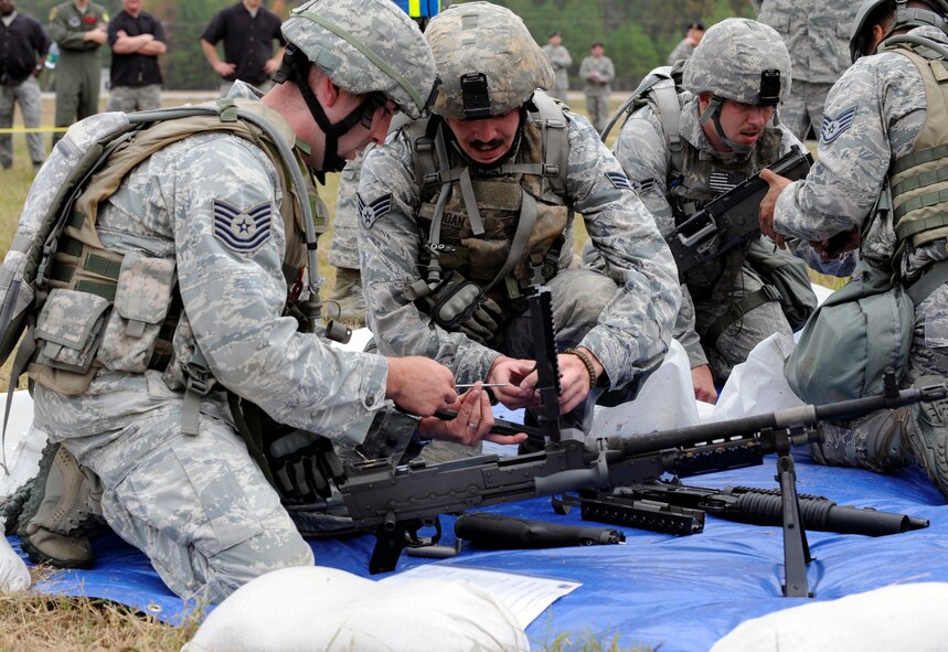 CAMP MINDEN, La. - Tech. Sgt. Chris Camera and Senior Airman James Doan, 509th Security Forces Squadron assemble a M240B Machine Gun during the mental and physical challenge during the Global Strike Challenge at Camp Minden, La., Nov. 7. The MAP Challenge consisted of eight phases--bounding over watch, range determination, Humvee push, ammunition can stacks, weapon assembly, logic event, physical event and a dead sprint to the finish line. (U.S. Air Force photo/Staff Sgt. Alexandra M. Boutte) (RELEASED)