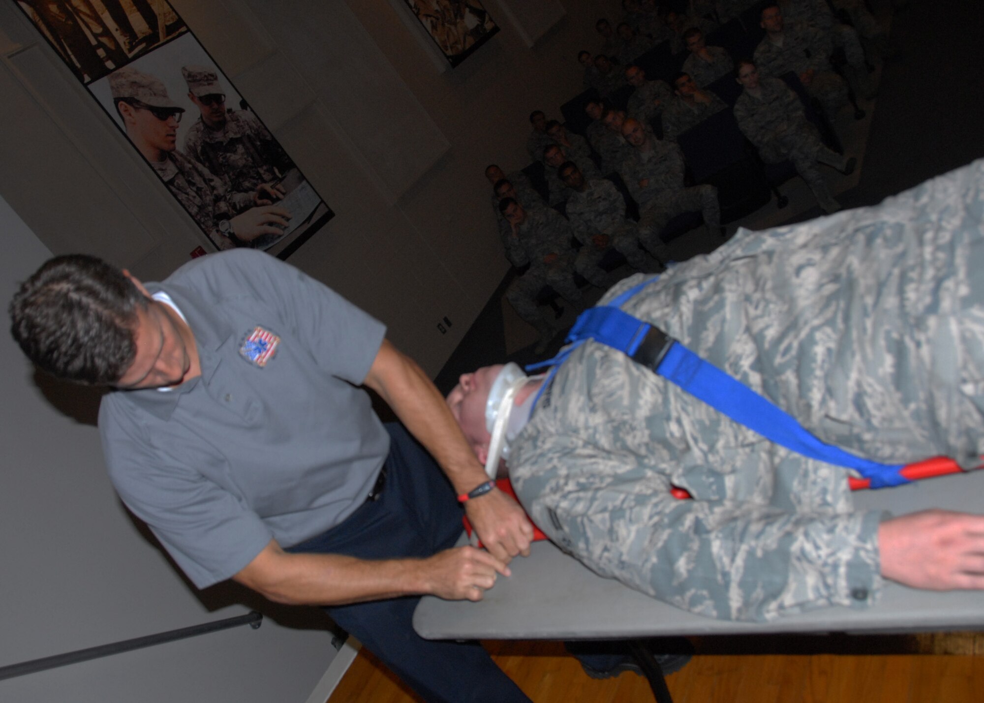 Airman 1st Class Corey Shanno, a member of the 96th Logistics Readiness Squadron, is placed on a spinal board for transportation to a hospital by Chris Stocks, a Florida Stay Alive From Education instructor, as part of a car accident victim demonstration during the “Street Smart” program at the Holiday Traffic Safety Campaign Nov. 17.  (U.S. Air Force photo/Kevin Gaddie)