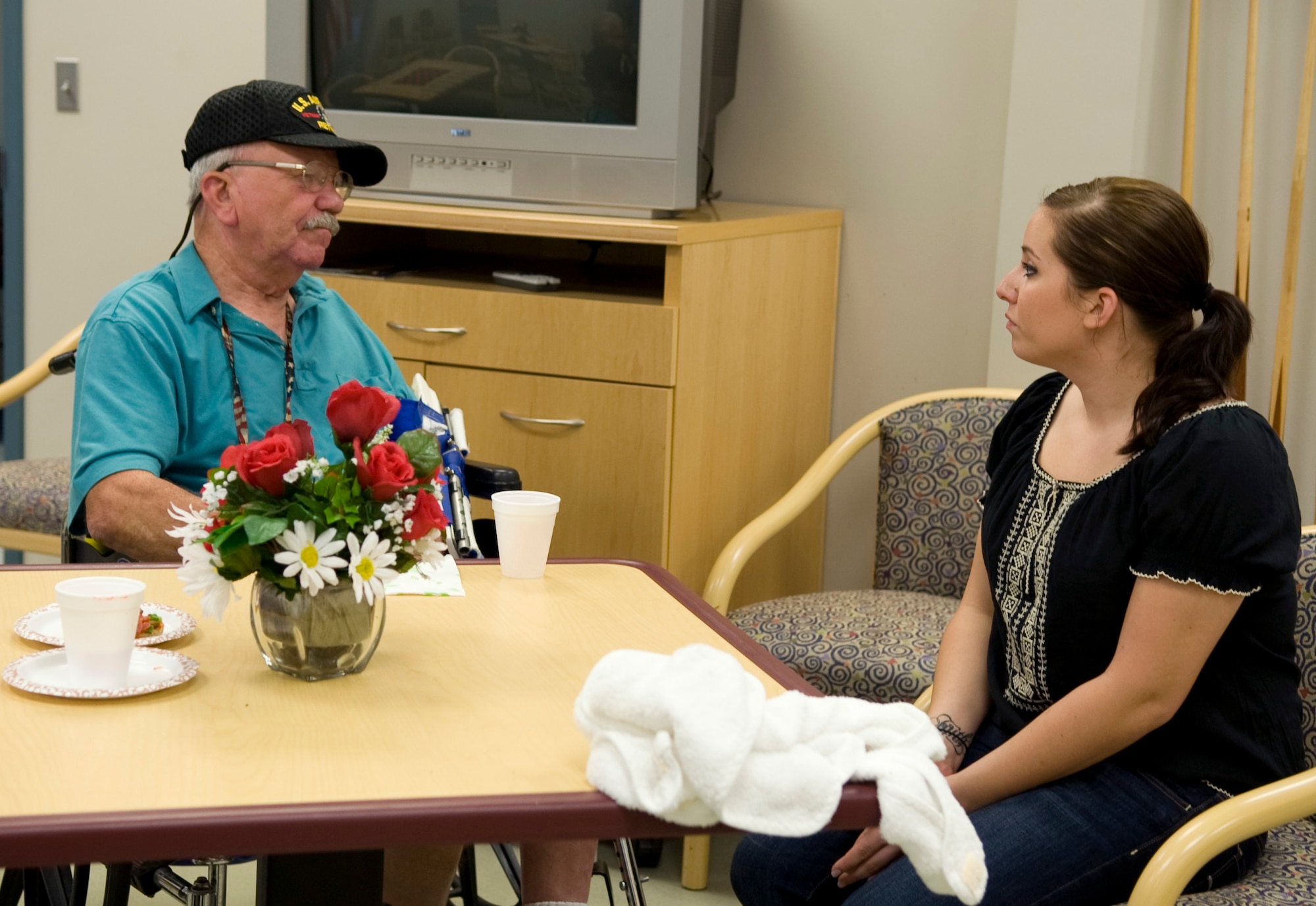 Senior Airman Madeline Conley, 2nd Operations Support Squadron, talks with a veteran at the Northwest Louisiana War Veterans home in Bossier City, La., Nov. 15. Members of Team Barksdale visited the veterans in order to show them appreciation for their past service. (U.S. Air Force photo/Airman 1st Class Benjamin Gonsier)(RELEASED)