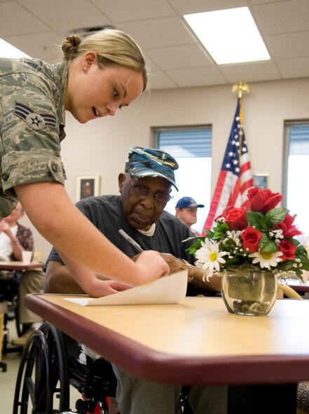 Senior Airman Katelyn Vargas, 2nd Operations Support Squadron, takes an order from a veteran at the Northwest Louisiana War Veterans home in Bossier City, La., Nov. 15. More than 20 veterans showed up to eat pizza and share some war stories with the Barksdale Airmen volunteers. Vargas was the coordinator for the event. (U.S. Air Force photo/Airman 1st Class Benjamin Gonsier)(RELEASED)