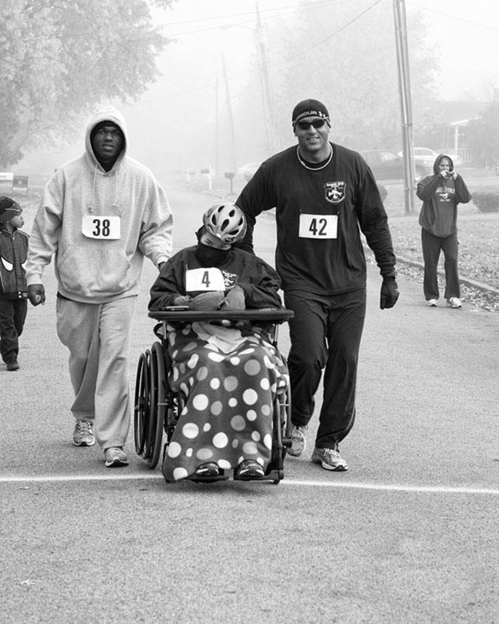 AEDC Firefighter Anthony Jimcoily and Assistant Fire Chief George Deshields push Victoria Atwell in the Snyder Foundatio's Cops and Kids 5K Run/Walk in Smyrna Nov. 5. (Photo by Kerry Kimmel Photography)
